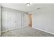 Bedroom featuring neutral carpet, double closet, and an open doorway at 4950 Chase Ct, St Cloud, FL 34772