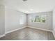 Bright bedroom with hardwood style floors, offering abundant natural light and modern aesthetic at 4950 Chase Ct, St Cloud, FL 34772