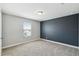 Empty bedroom with neutral carpet, window and dark accent wall at 4950 Chase Ct, St Cloud, FL 34772