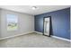 Bedroom featuring a large window for natural light and a stylish accent wall with full length mirror at 4950 Chase Ct, St Cloud, FL 34772