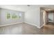 Hardwood-style floored bedroom with ample natural light, leading to a hallway at 4950 Chase Ct, St Cloud, FL 34772