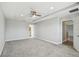 Large bedroom with gray carpet, tray ceiling, and an ensuite bathroom and walk-in closet at 4950 Chase Ct, St Cloud, FL 34772