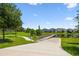 View of a community boat dock and boat ramp surrounded by green lawns and trees at 4950 Chase Ct, St Cloud, FL 34772