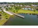 Aerial view of a boat dock leading to lake and community pool with clubhouse at 4950 Chase Ct, St Cloud, FL 34772
