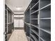 Walk-in closet with custom shelves and carpeted floor at 4950 Chase Ct, St Cloud, FL 34772