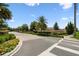 A beautifully landscaped entrance to Hanover Lakes with a brick-paved roundabout and lush greenery at 4950 Chase Ct, St Cloud, FL 34772