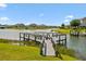 Well-maintained dock with boat lift provides a private retreat for enjoying water activities on the serene lake at 4950 Chase Ct, St Cloud, FL 34772