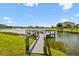Lakeside dock equipped with boat lift offers a perfect spot for relaxation and enjoying the scenic waterfront at 4950 Chase Ct, St Cloud, FL 34772