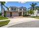 Charming two-story home featuring a brick driveway, lush landscaping, and a spacious three-car garage at 4950 Chase Ct, St Cloud, FL 34772
