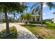Attractive home with well-manicured lawn, brick driveway, and mature palm trees on a sunny day at 4950 Chase Ct, St Cloud, FL 34772