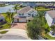 Stunning two-story home boasts a brick driveway, three-car garage, and lush landscaping at 4950 Chase Ct, St Cloud, FL 34772