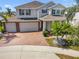 Beautiful two-story home with a two-car garage, brick driveway, manicured lawn and mature landscaping at 4950 Chase Ct, St Cloud, FL 34772