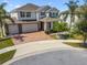 Beautiful two-story home with a two-car garage, brick driveway, manicured lawn and mature landscaping at 4950 Chase Ct, St Cloud, FL 34772