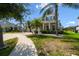 Beautiful home with well-manicured lawn, brick driveway, and mature palm trees on a sunny day at 4950 Chase Ct, St Cloud, FL 34772
