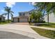 Well-maintained two-story home with a three-car garage, brick driveway, and lush landscaping in a sunny neighborhood at 4950 Chase Ct, St Cloud, FL 34772
