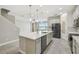 Open-concept kitchen featuring a large island, stainless appliances, and tile flooring at 4950 Chase Ct, St Cloud, FL 34772