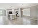 Open-concept kitchen with gray cabinets, tile floors, a large island, and stainless steel appliances at 4950 Chase Ct, St Cloud, FL 34772