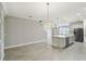 Open-concept kitchen featuring a large island, stainless appliances, and tile flooring at 4950 Chase Ct, St Cloud, FL 34772