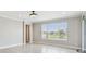Bright living room with tile flooring, large windows, and neutral wall colors at 4950 Chase Ct, St Cloud, FL 34772
