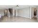 Open-concept living space with tile floors, staircase, and doorways to bedrooms and bathrooms at 4950 Chase Ct, St Cloud, FL 34772