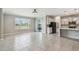 Open concept living area with tile floors connecting the kitchen with modern, black appliances at 4950 Chase Ct, St Cloud, FL 34772