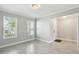 Bright and airy living room with tile flooring, large windows, and a view of the front entry at 4950 Chase Ct, St Cloud, FL 34772