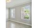 Bright living room with large windows, blinds, neutral paint, and tile flooring at 4950 Chase Ct, St Cloud, FL 34772
