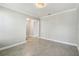 Open living room with decorative light fixture, neutral paint, tile flooring, and an open doorway at 4950 Chase Ct, St Cloud, FL 34772