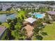 Aerial view of community playground with swings, slides, and covered play area near a tranquil pond at 4950 Chase Ct, St Cloud, FL 34772