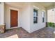 Inviting front porch with brick flooring, columns, and a stylish front door at 4950 Chase Ct, St Cloud, FL 34772