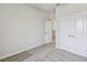 This bedroom features neutral walls, carpet flooring, and closet and entry doors at 6690 Wake St, St Cloud, FL 34771