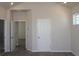 Carpeted bedroom featuring ensuite bathroom, white doors, and bright window at 6690 Wake St, St Cloud, FL 34771