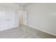 This bedroom features neutral walls, carpet flooring, and closet and entry doors at 6690 Wake St, St Cloud, FL 34771