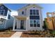 Charming two-story home with a modern design, large windows, and a welcoming front porch at 6690 Wake St, St Cloud, FL 34771