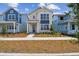 Charming two-story home with blue accents and a well-maintained front yard at 6690 Wake St, St Cloud, FL 34771