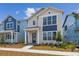 Charming two-story home with blue accents and a well-maintained front yard at 6690 Wake St, St Cloud, FL 34771