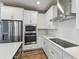 Bright kitchen features white cabinets, stainless steel appliances, and a modern cooktop at 6690 Wake St, St Cloud, FL 34771