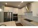 Modern kitchen featuring stainless steel appliances, white cabinets, and stylish countertops at 6690 Wake St, St Cloud, FL 34771