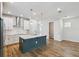 Open kitchen featuring stainless steel appliances, white cabinetry, and a large center island at 6690 Wake St, St Cloud, FL 34771