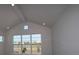 Living room showcasing vaulted ceiling, recessed lighting, and a large window offering scenic views at 6690 Wake St, St Cloud, FL 34771