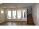 Bright living room with wood floors, large windows and staircase at 6690 Wake St, St Cloud, FL 34771