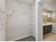 Walk-in closet with wire shelving and doorway to bathroom at 6690 Wake St, St Cloud, FL 34771