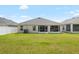 Large, level backyard with lush green grass, bordered by a pristine white fence, offering ample space at 3839 White Ibis Rd, Lakeland, FL 33811
