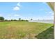 Expansive backyard with healthy green grass and a white fence, offering a sense of openness and privacy at 3839 White Ibis Rd, Lakeland, FL 33811