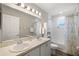 Well-lit bathroom features a double sink vanity with framed mirror and a shower and bathtub combo at 3839 White Ibis Rd, Lakeland, FL 33811