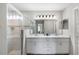 En-suite bathroom with double vanity, tiled shower with glass door, and modern fixtures at 3839 White Ibis Rd, Lakeland, FL 33811