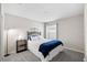 This neutral colored bedroom with carpet features a queen bed and a large window with lots of light at 3839 White Ibis Rd, Lakeland, FL 33811