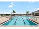 Sparkling community pool with clear blue water, plenty of lounge chairs, and shaded areas for relaxation at 3839 White Ibis Rd, Lakeland, FL 33811