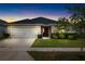 Charming single-story home with a well-manicured lawn, two-car garage, and a dark roof at 3839 White Ibis Rd, Lakeland, FL 33811