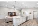 Modern kitchen with stainless steel appliances, a central island, and white cabinetry at 3839 White Ibis Rd, Lakeland, FL 33811